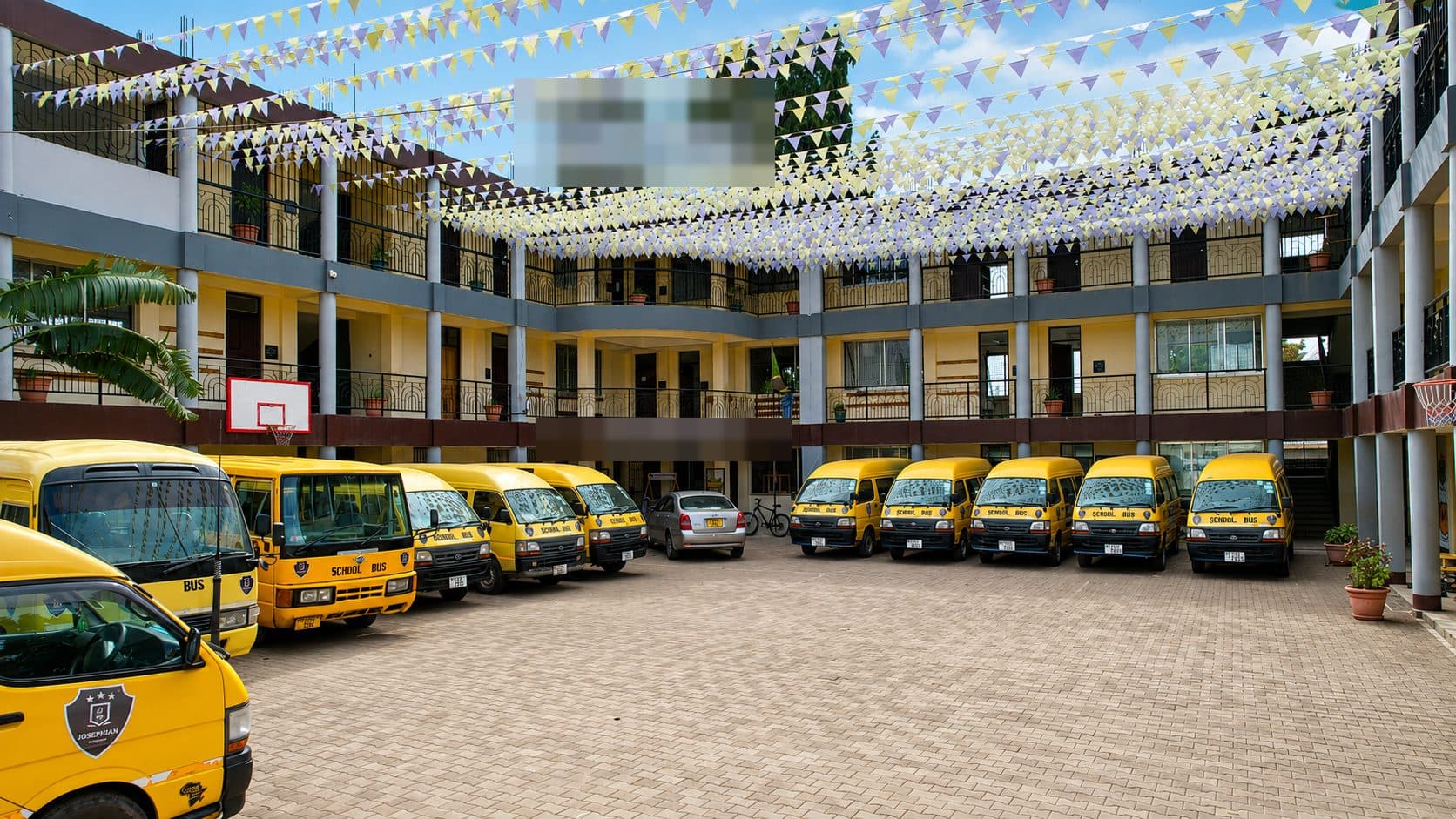 Coordinated fleet of Tuende Shule school buses lined up and ready for daily routes
