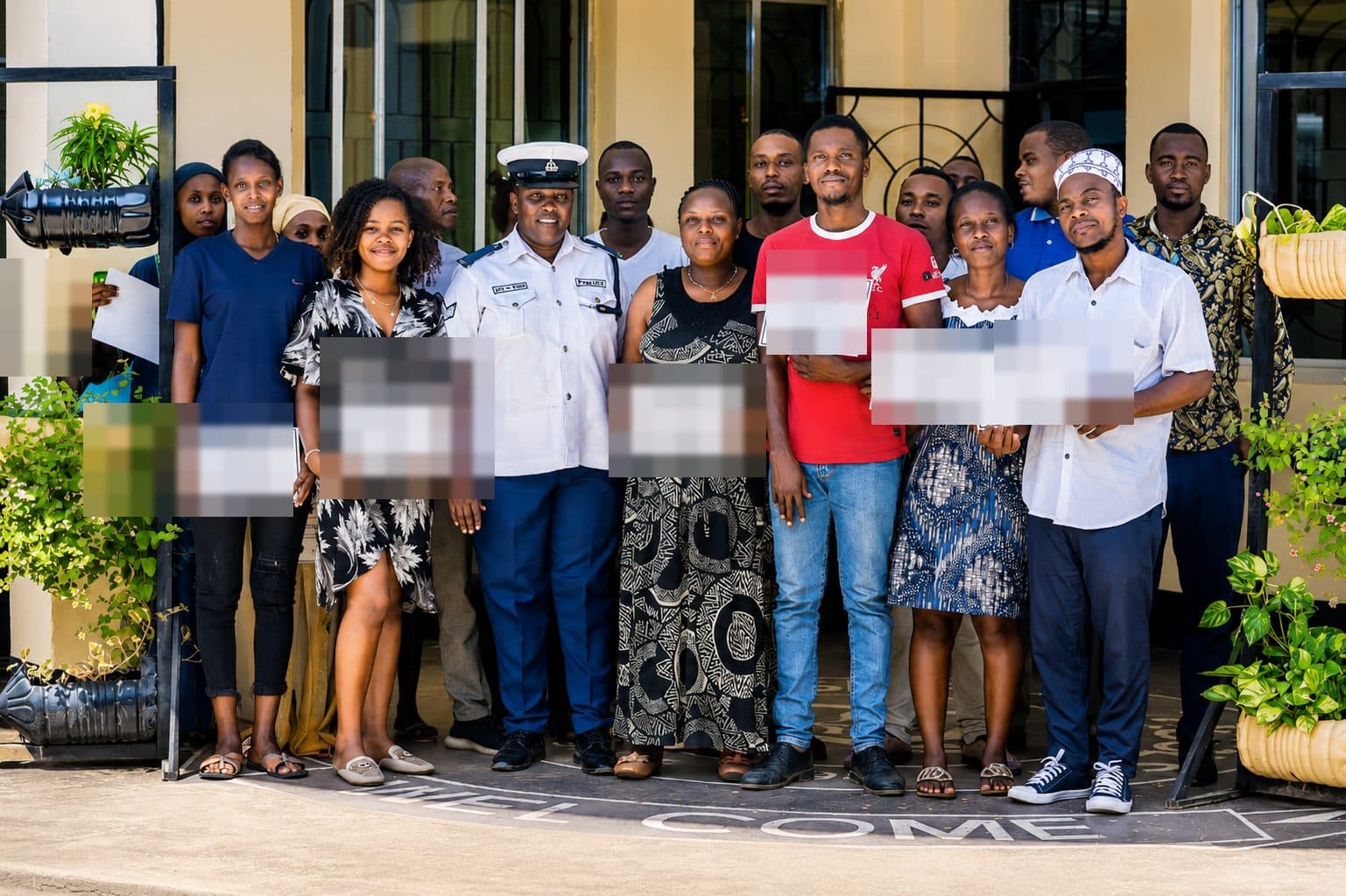 Tuende Shule team members holding certificates after a road safety training session